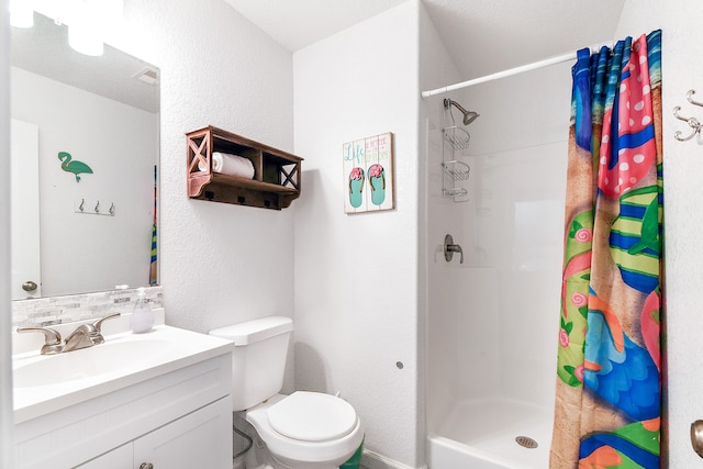 bathroom featuring toilet, vanity with extensive cabinet space, and walk in shower