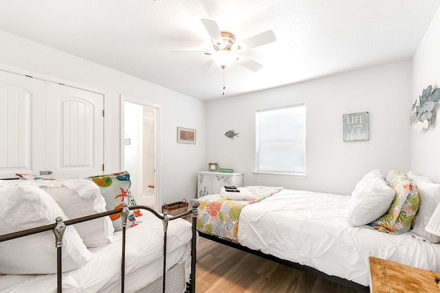 bedroom featuring ceiling fan, hardwood / wood-style floors, and a closet