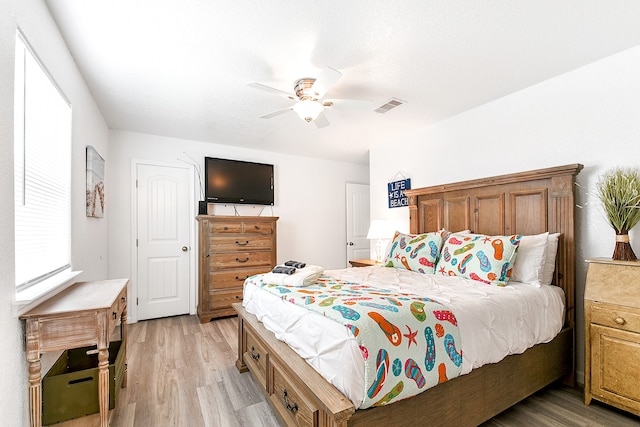 bedroom with ceiling fan and light wood-type flooring