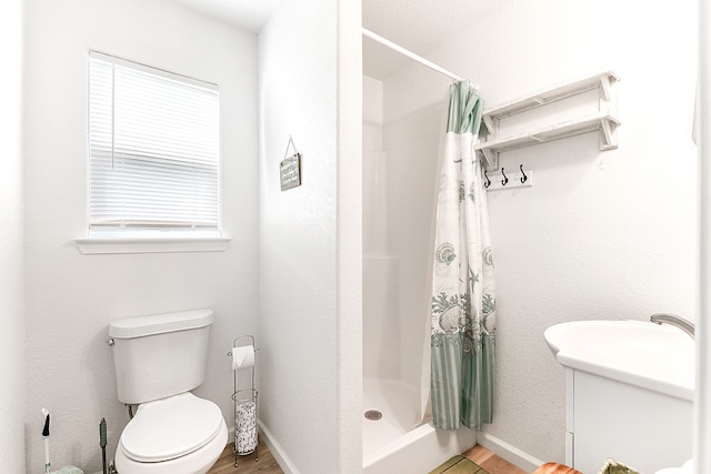 bathroom with a shower with curtain and toilet