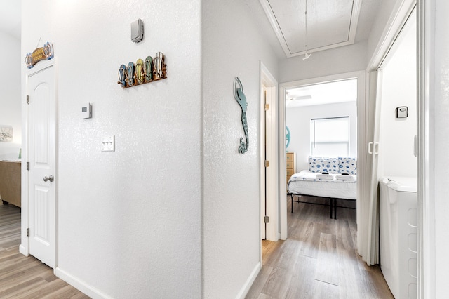 corridor with light hardwood / wood-style floors