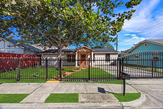 bungalow-style home with a front yard