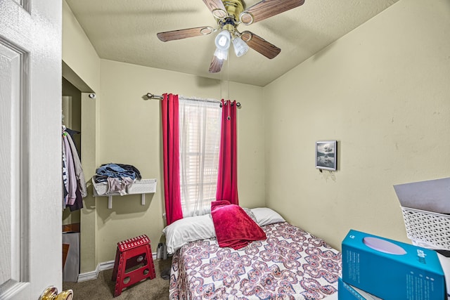 bedroom featuring ceiling fan, a textured ceiling, and carpet flooring