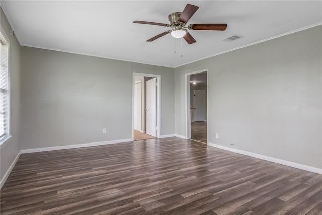 empty room with crown molding, ceiling fan, and dark wood-type flooring