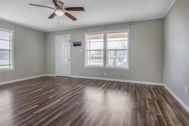 spare room featuring ceiling fan, dark wood-type flooring, and ornamental molding