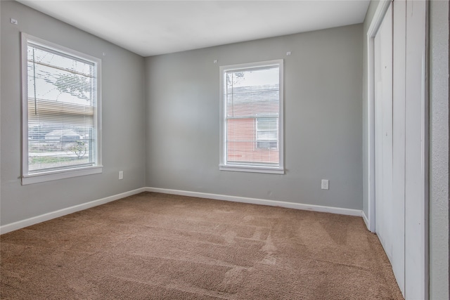 carpeted spare room with plenty of natural light