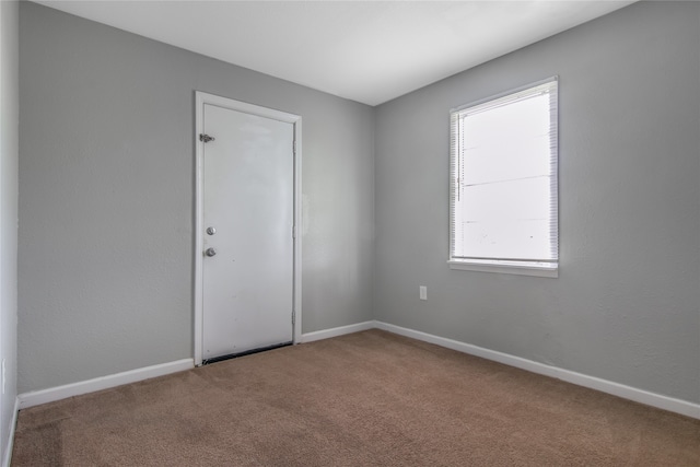 empty room featuring dark carpet