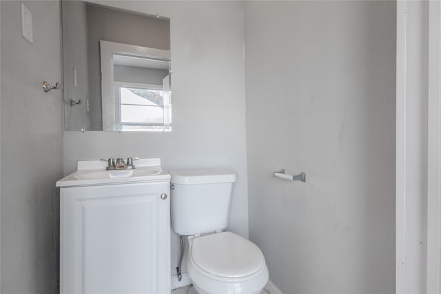 bathroom featuring toilet and vanity