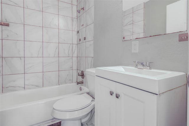 full bathroom featuring tiled shower / bath combo, toilet, and vanity with extensive cabinet space