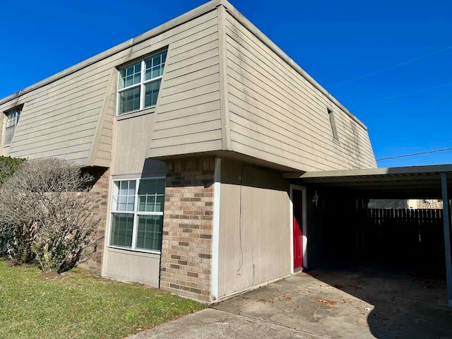 view of side of property with a carport