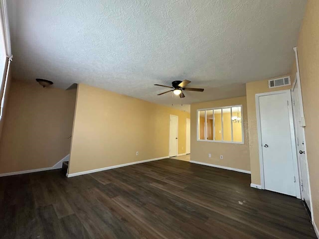 unfurnished room featuring a textured ceiling, ceiling fan, and dark hardwood / wood-style flooring