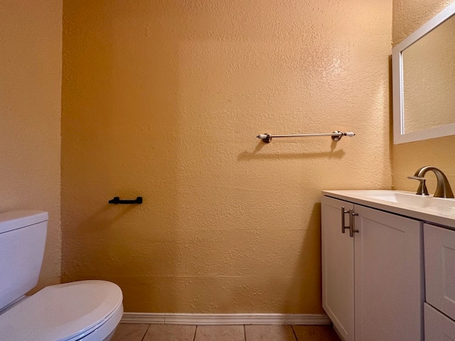 bathroom featuring tile floors, toilet, and vanity