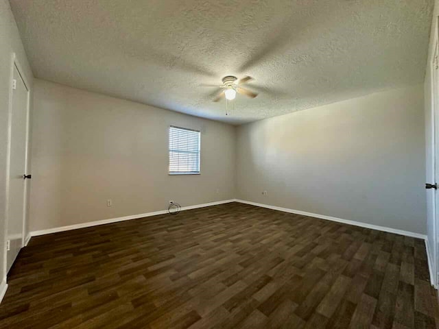 empty room featuring ceiling fan, a textured ceiling, and dark hardwood / wood-style floors