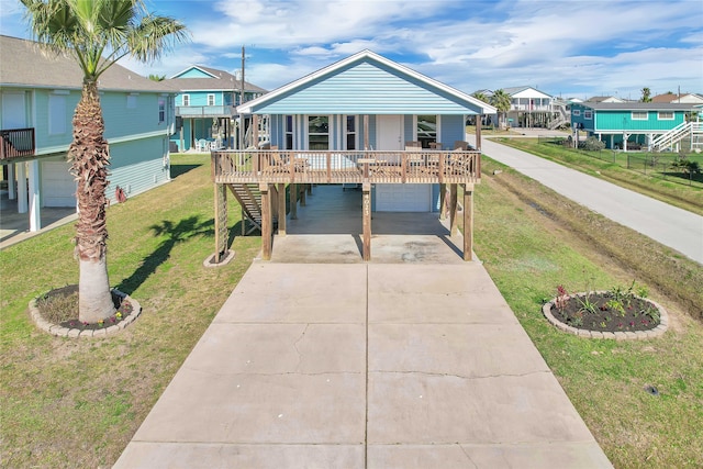 beach home with a front yard and a garage