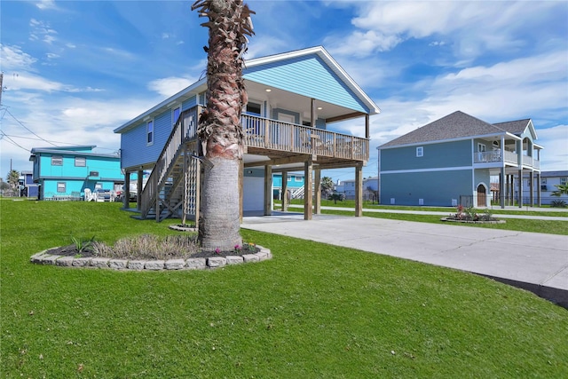 rear view of property featuring driveway, stairs, a carport, and a yard