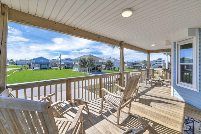 wooden deck featuring a lawn and a residential view
