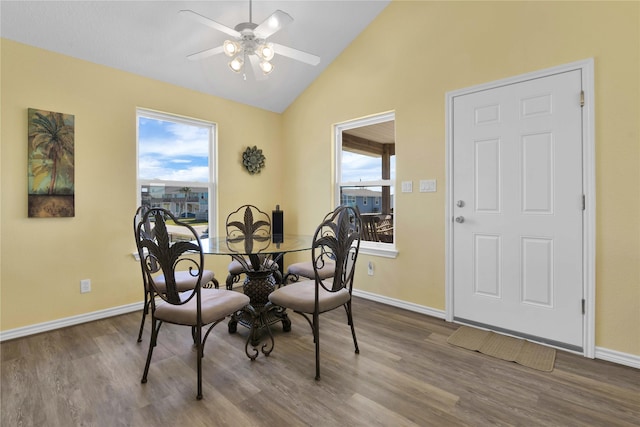 dining room featuring a healthy amount of sunlight, baseboards, a ceiling fan, and wood finished floors