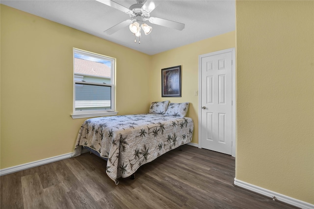 bedroom with ceiling fan and dark wood-type flooring