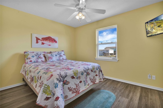 bedroom with baseboards, ceiling fan, and wood finished floors
