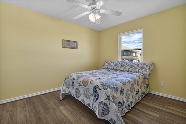 bedroom with ceiling fan and dark hardwood / wood-style flooring