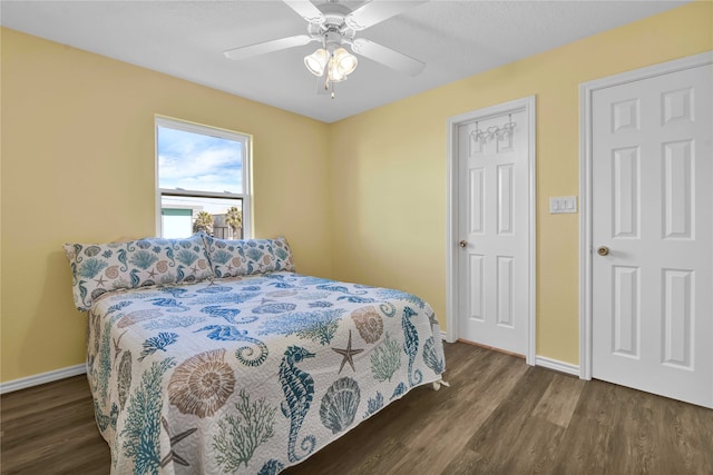 bedroom featuring ceiling fan and dark wood-type flooring