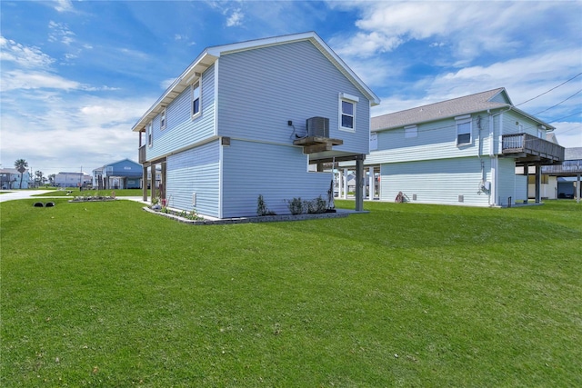 back of property featuring a yard and central AC