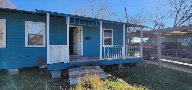 view of exterior entry featuring a porch