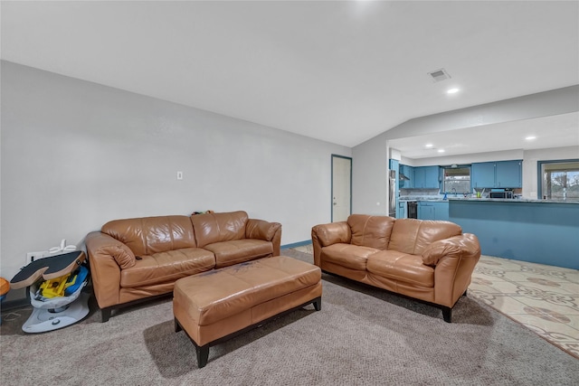 carpeted living room featuring vaulted ceiling