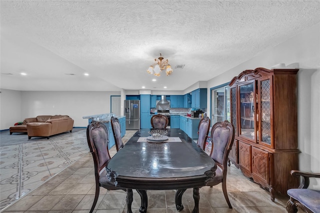 dining space featuring a chandelier and a textured ceiling