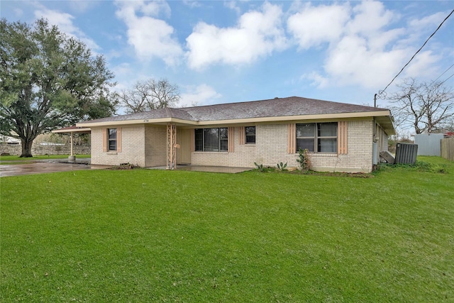 ranch-style home with a front lawn and a carport