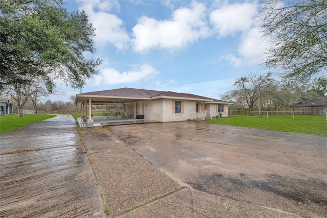 view of front facade with a front lawn and a carport