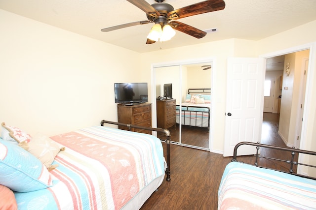 bedroom with a closet, dark hardwood / wood-style floors, and ceiling fan