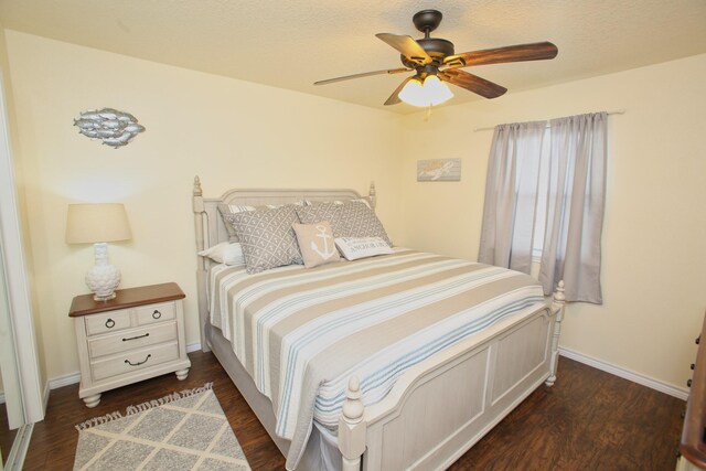 bedroom featuring dark hardwood / wood-style flooring and ceiling fan