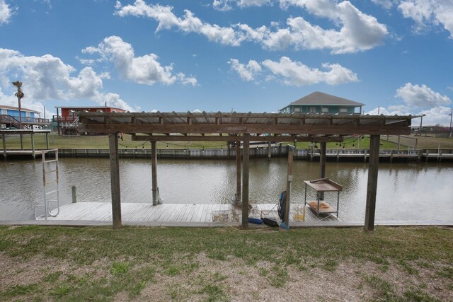 dock area with a water view and a lawn