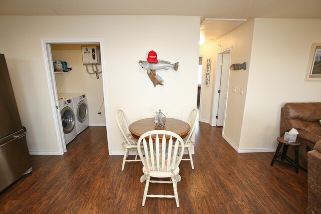 dining room featuring dark hardwood / wood-style floors, water heater, and independent washer and dryer