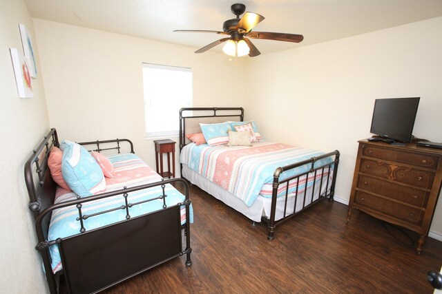 bedroom with ceiling fan and dark hardwood / wood-style flooring