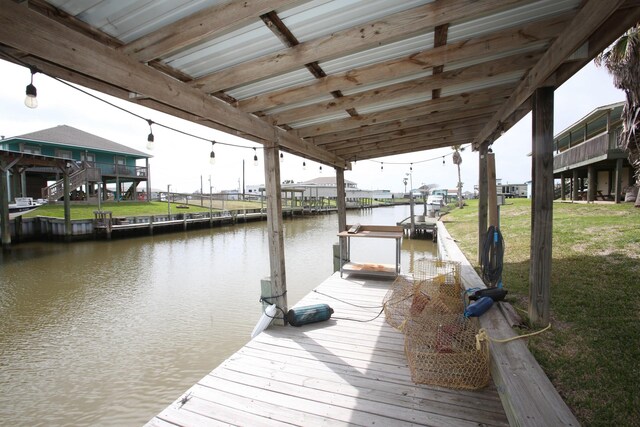 view of dock featuring a water view and a lawn