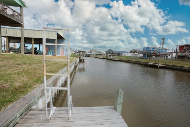 dock area with a water view and a lawn