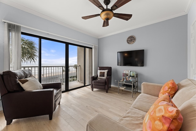 living room featuring ceiling fan, crown molding, and light hardwood / wood-style flooring