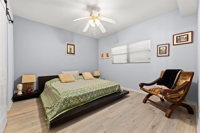 bedroom featuring light hardwood / wood-style floors and ceiling fan