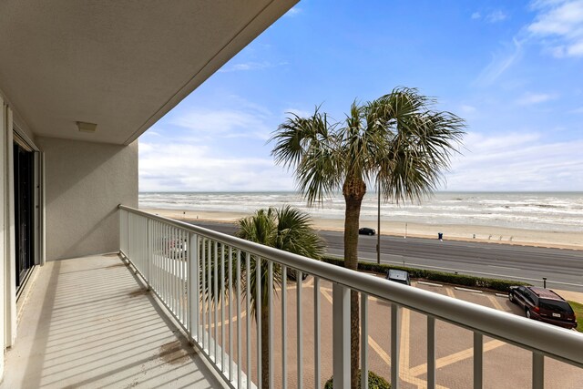 balcony with a view of the beach and a water view