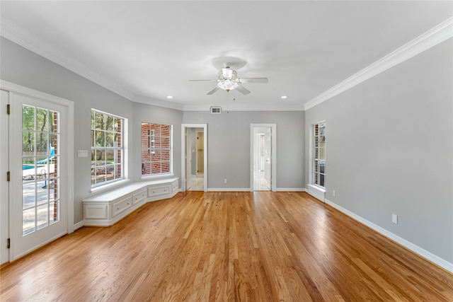 unfurnished room featuring ornamental molding, light hardwood / wood-style flooring, and ceiling fan