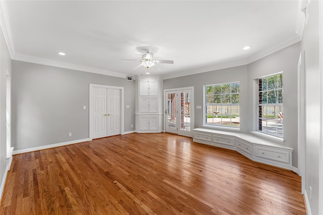 interior space featuring crown molding, light wood-type flooring, and ceiling fan