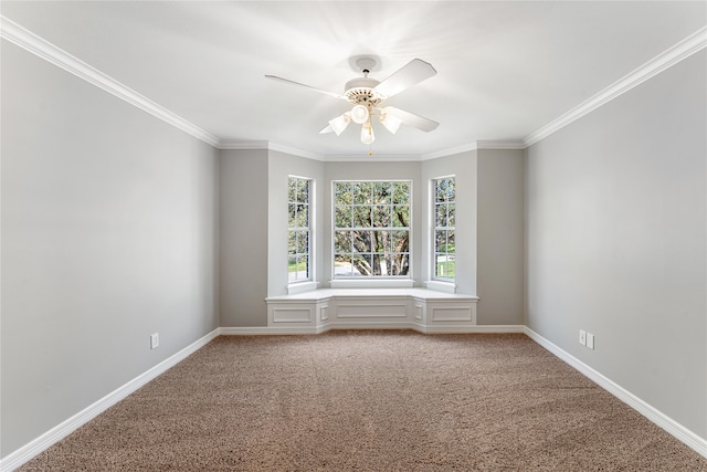 carpeted empty room featuring ornamental molding and ceiling fan