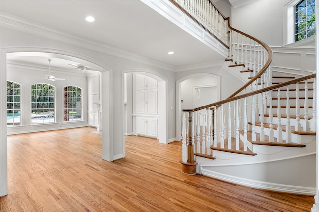 entryway featuring crown molding and light hardwood / wood-style floors