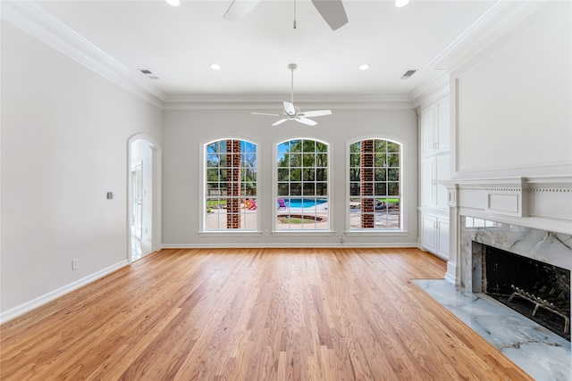 unfurnished living room featuring ornamental molding, light hardwood / wood-style flooring, and ceiling fan