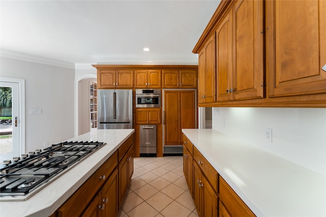 kitchen with stainless steel appliances, light tile patterned flooring, and crown molding