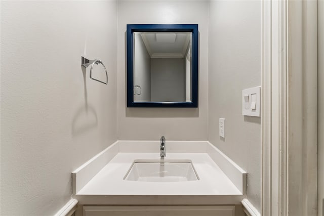 bathroom with vanity and ornamental molding