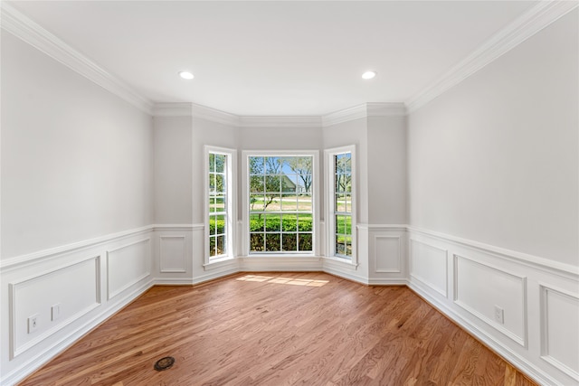 unfurnished room featuring crown molding and light hardwood / wood-style floors