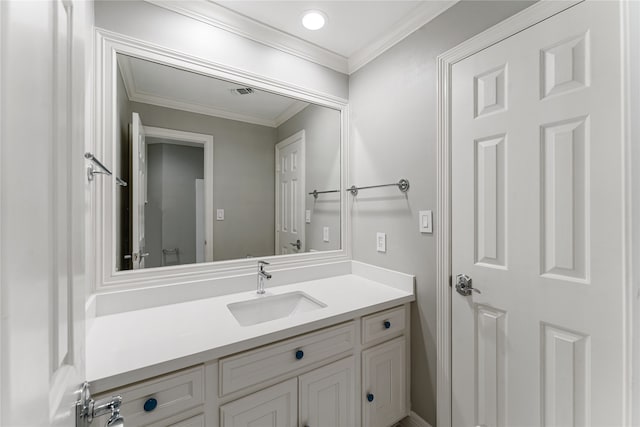 bathroom featuring ornamental molding and vanity